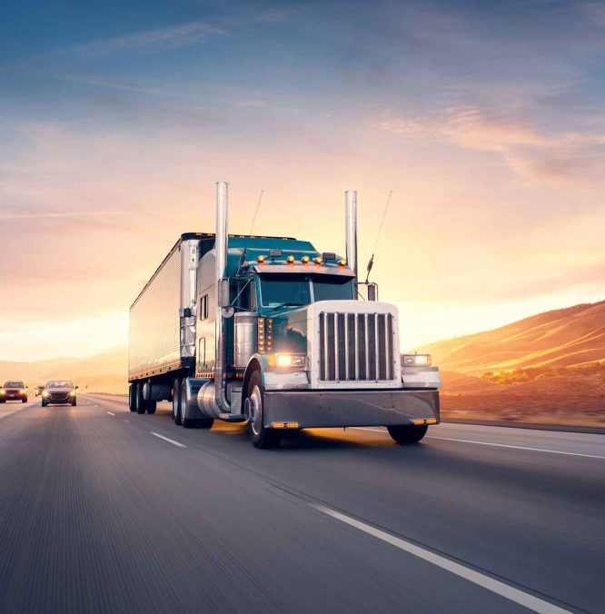 Truck-on-bitumen-road-at-sunset