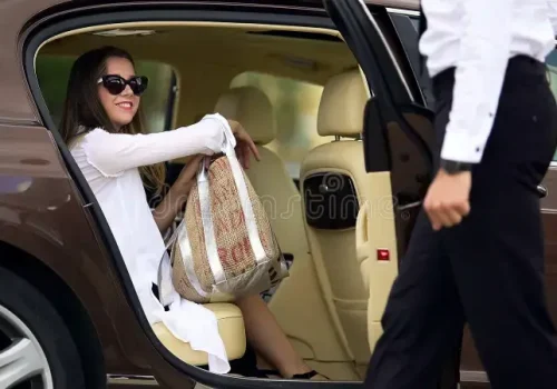 luxury-taxi-service-chauffeur-opening-car-door-female-passenger-travel-stock-footage-luxury-taxi-service-chauffeur-opening-car-112750806 (1)